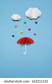 Creative valentines concept photo umbrella and hearts raining down white background 