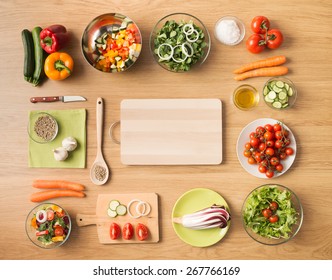 Creative Vegetarian Cooking At Home Concept With Fresh Healthy Vegetables Chopped, Salads And Kitchen Wooden Utensils, Top View With Copy Space