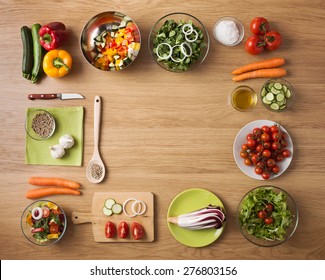 Creative Vegetarian Cooking At Home Concept With Fresh Healthy Vegetables Chopped, Salads And Kitchen Wooden Utensils, Top View With Copy Space