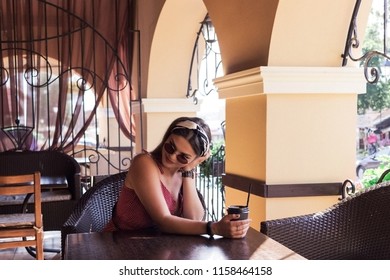 A Creative Vintage Photo Of A Beautiful Pin-up Girl Drinking Tea And Showing Good Table Manners.