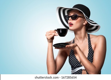 A Creative Vintage Photo Of A Beautiful Pin-up Girl Drinking Tea And Showing Good Table Manners.