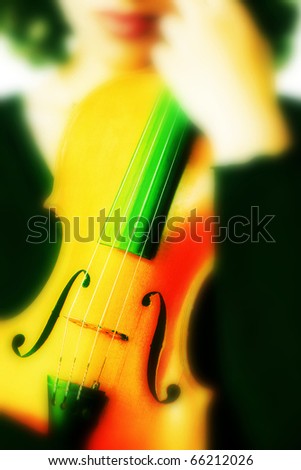 Creative violin. Colorful artistic violin in the woman's hands.