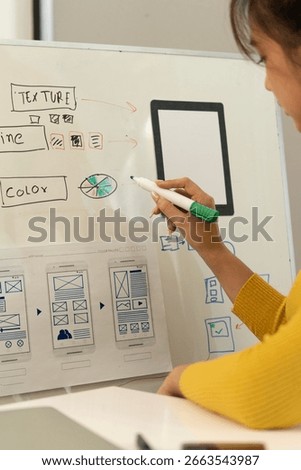 Creative web designer brainstorming app interface and designing digital templates in a modern workspace. UX UI development process in a professional tech environment.