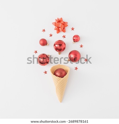 Creative winter holiday flat lay with red baubles and waffle cone. Fun minimal concept of Christmas and imagination. Flat lay composition celebrating creativity and festive spirit.