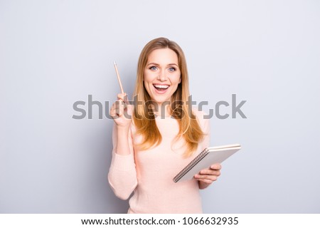 Creative work worker teenager list joy plan moment science learn author blonde hair people person concept. Clever intelligent excited lady holding notebook pen in hands isolated on gray background
