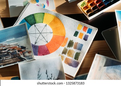 Creative workplace. Artistic inspiration. Painter artworks and art supplies around. - Powered by Shutterstock