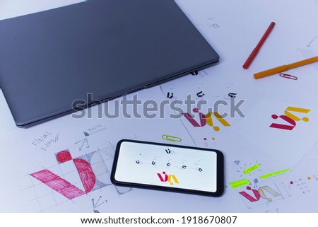 Creative workplace of a Graphic Designer. Development of a logo for the company. Drawings and sketches on paper in a art studio office