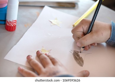 Creative Workshop For Kids. Little Boy With Dirty Hands Drawing On White Paper At School. Concept Of Art, Crafts And Kids Having Fun. Messy Table