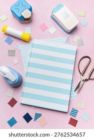 Creative workshop tools arranged on a pink surface for a hobby project