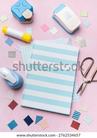 Creative workshop tools arranged on a pink surface for a hobby project