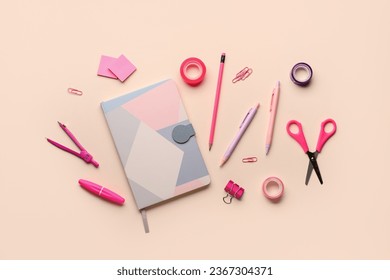 Creative workspace flat lay with pink and purple stationery, notebook, pens, pencils, scissors, and office supplies