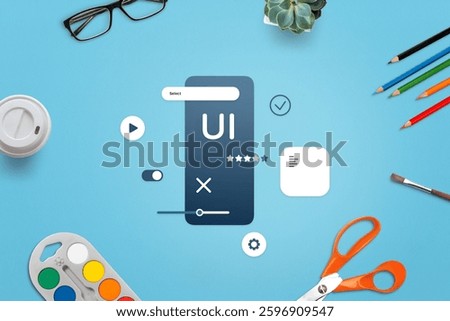Creative workspace for mobile app development, top view of UI design process with various artistic tools and accessories. Top view, flat lay