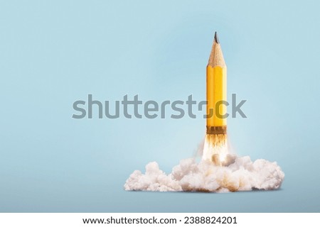 Creative yellow pencil successfully takes off with smoke and blast on a blue background, creative idea. Start-up and development, concept. Back to school. Grow and brainstorm