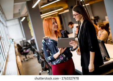 Creative young female executives using digital tablet in office