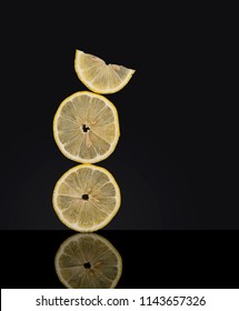 Creatively Balanced Fresh Lemon Fruit Slices On Dark Background. Unusual Photo. Seem To Defy Gravity 