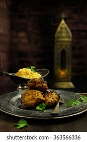 Creatively lit Indian Onion Bhajis with pilau rice against an authentically Indian dark, rustic styled background. The perfect image for your Indian menu cover design. Accommodation for copy space.