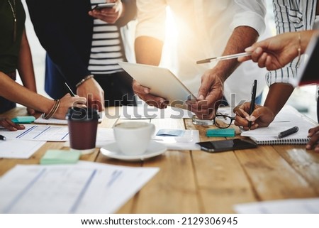 Creativity, brainstorming, planning, teamwork, execution then success. Shot of a group of unrecognizable people working together in a modern office.