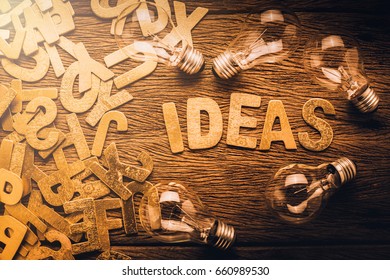 creativity ideas concept with light bulb on wooden texture background