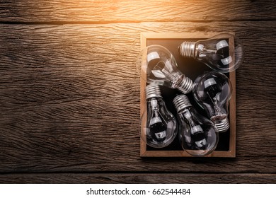 creativity ideas concept with light bulb on chalkboard on wooden texture background with free copyspace for your ideasd texts