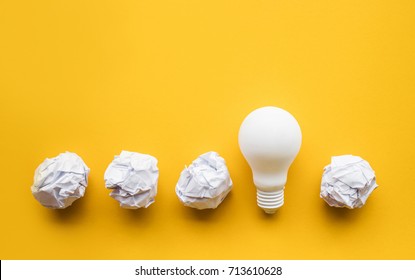 Creativity Inspiration,ideas Concepts With Lightbulb And Paper Crumpled Ball On Pastel Color Background.Flat Lay Design.