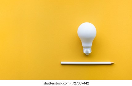 Creativity inspiration,ideas concepts with lightbulb and pencil on pastel color background.Flat lay design.