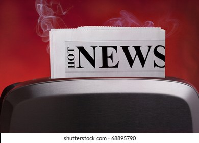 Creativity on "Hot News ". In the frame of a toaster and a news paper.