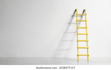 Creativity,solution,innovation,idea,thinking out of the box concept, blue painted wall with ladder of success. Large free copy space,negative space technique