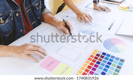 Creator designing mobile user interface layout prototype.