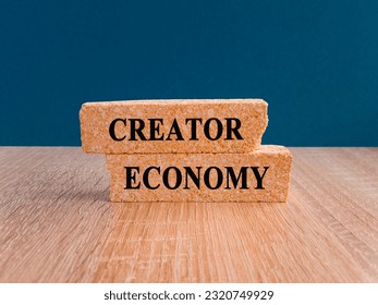 Creator economy symbol. Brick blocks with words Creator economy on beautiful blue background, copy space. Business and creator economy concept