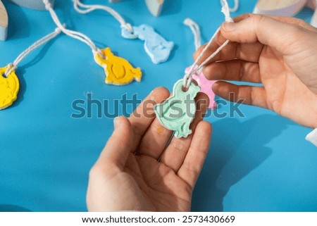 Creator is using white air dry clay for making decor to EASTER holiday. Creating hobby recreation activity that involves fingers. DIY crafting