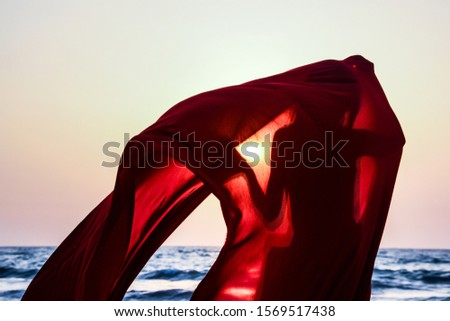 Similar – Colorful striped, closed parasol in close-up on the beach at sunset