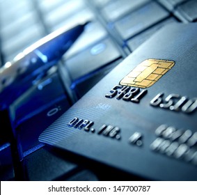 Credit card and ball pen on a laptop - Shutterstock ID 147700787