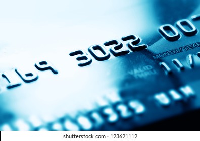 Credit card in blue tone. Selective focus.