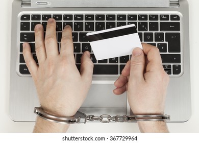 Credit Card Cheater With Handcuff On Laptop