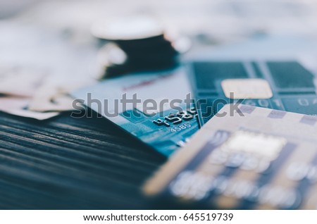 Credit card, coins and money on the table