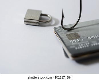 Credit card fraud, phishing, data security encryption concept - Credit card with blurred information and bait hook and key lock.