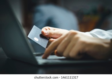 With A Credit Card In Hand, I Am Using My Laptop To Do Online Shopping.