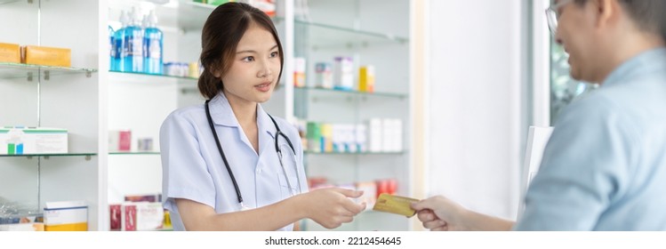 Credit Card Payment, Male Patient Pays By Credit Card To A Pharmacist In A Pharmacy, Get Service At A Community Pharmacy , Pharmacist Or Cashier Scanning Medicinal Products At Checkout.