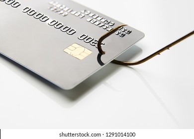 Credit card phishing attack. Credit card and fish hook, close-up. Credit card fraud data leak money stealing phishing concept