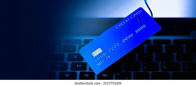 Credit Card Phishing - Piles Of Credit Cards With A Fish Hook On Computer Keyboard