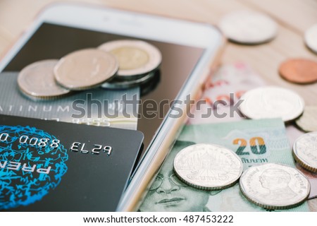 Credit card,  plastic money, put on smartphone and bank note. Electronic money and ewallet concept, new payable in Fintech era.