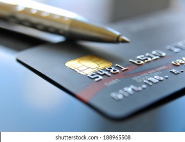 Credit card with silver colored ballpoint pen