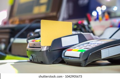 Credit Card Swipe On Card Reader Machine On Cashier Counter For Shopping