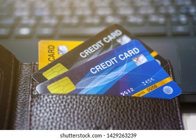 Credit Cards In Leather Wallet On Laptop.  Business Techology Do Moneyless Transaction By Plastic Cards For Buy Sell Offline And Online Shopping.