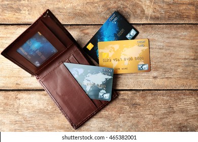 Credit Cards In Leather Wallet On Wooden Background