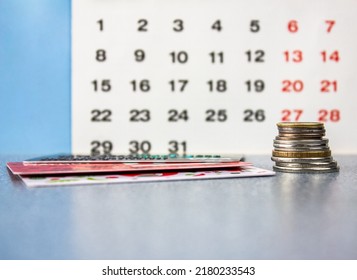 The Credit cards and money on the background of the calendar.Payment term.Credit,installment plan,mortgage. - Shutterstock ID 2180233543