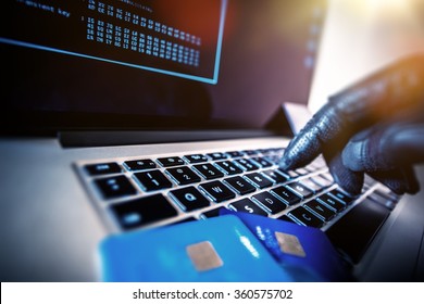 Credit Cards Theft Concept. Hacker with Credit Cards on His Laptop Using Them For Unauthorized Shopping. Unauthorized Payments