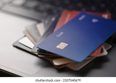 Credit And Deposit Cards On A Computer Keyboard. Electronic Commerce, Business. Online Shopping, New Technologies In Finance, Economics And Trade. Close-up. There Are No People In The Photo.