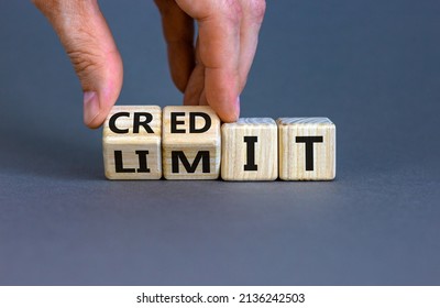 Credit limit symbol. Businessman turns wooden cubes and changes the word 'limit' to 'credit'. Beautiful grey table, grey background, copy space. Business and credit limit concept.