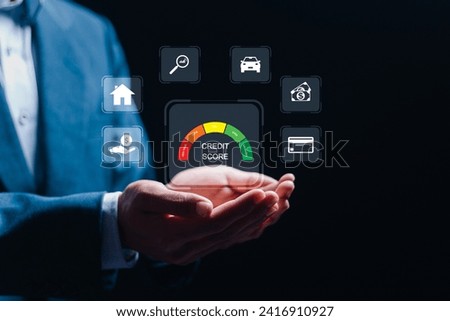 Credit score concept, businessman holding virtual screen of credit score icon for chart with credit history values. Online credit score ranking check. student loan, mortgage and payment cards.